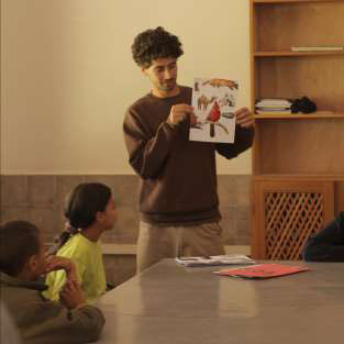 Chidlren listening to guitar at the skatepark Fiers & Forts